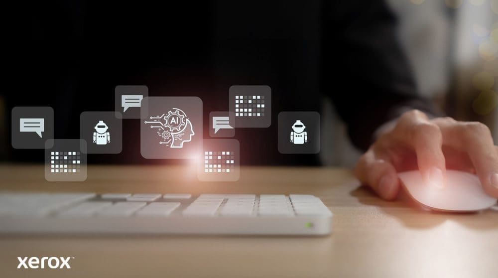 Xerox® DocuShare® Go: Gestión inteligente de documentos La mano de una persona está sobre un mouse de computadora, con íconos brillantes abstractos relacionados con la comunicación, la IA y el procesamiento de datos flotando sobre el teclado, representando funcionalidades de documentos inteligentes.